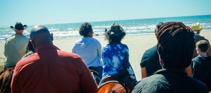 Group horseback ride on the beach